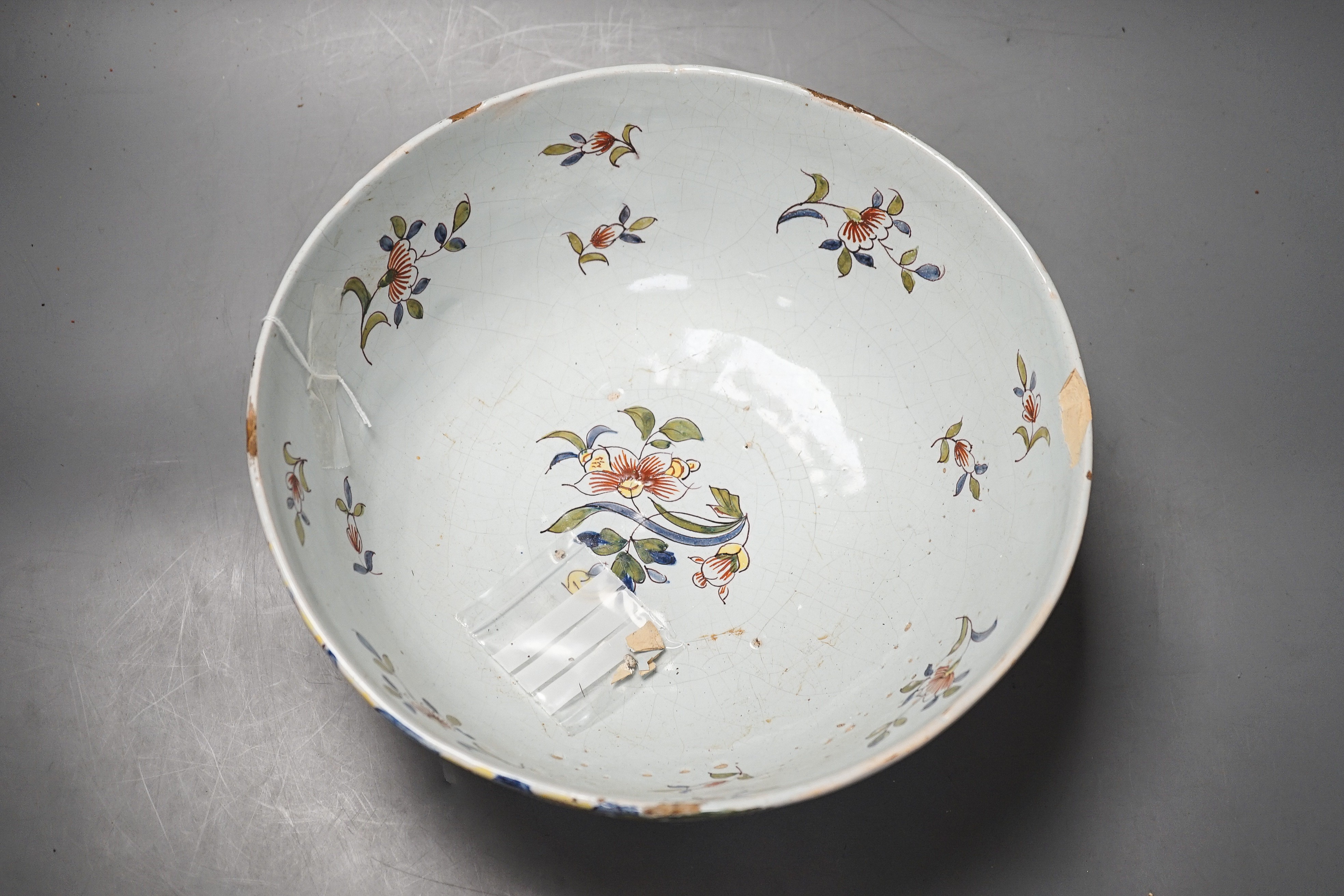 Lord Admiral Nelson. A commemorative Delftware punch bowl, 19th century, painted in polychrome with a portrait of Nelson, as hip and floral sprays, D. 30cm, splinter chip to edge